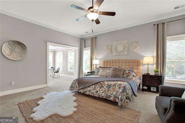 carpeted bedroom with crown molding, ceiling fan, visible vents, and baseboards