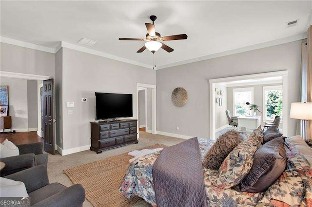 bedroom with crown molding, carpet, visible vents, and baseboards