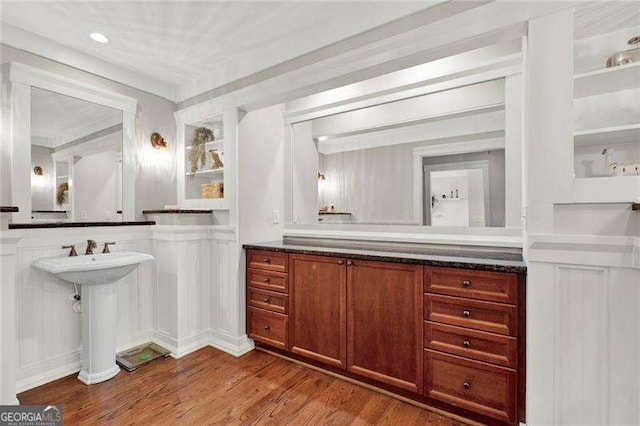 bathroom with a sink and wood finished floors