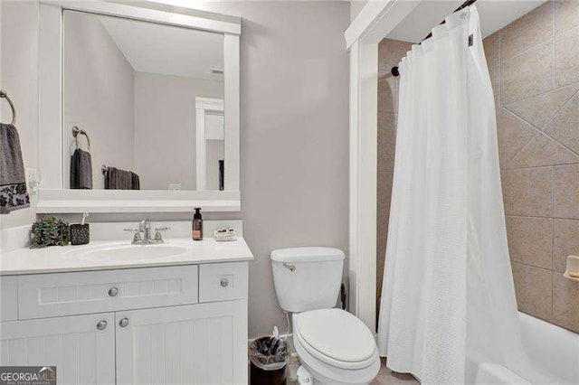 bathroom with shower / bath combo, vanity, and toilet