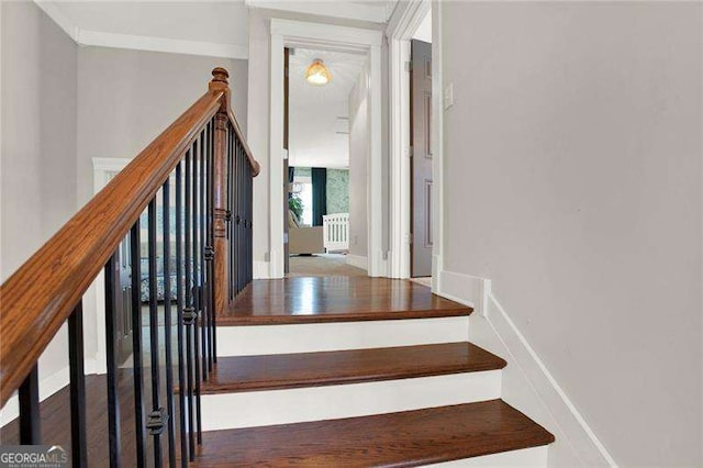 stairway featuring wood finished floors and baseboards