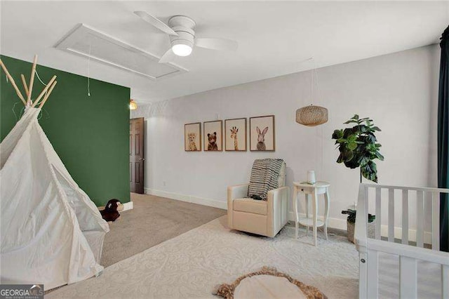 bedroom with attic access, carpet floors, baseboards, and a ceiling fan