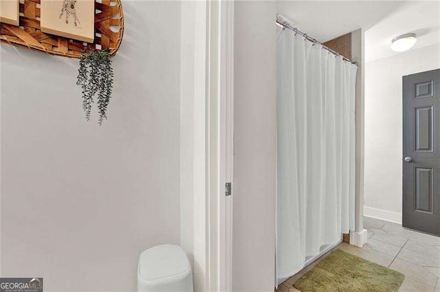 bathroom featuring tile patterned flooring and a shower with curtain