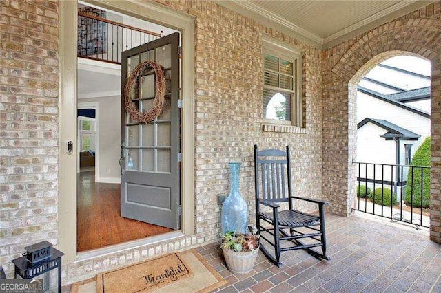 doorway to property featuring brick siding