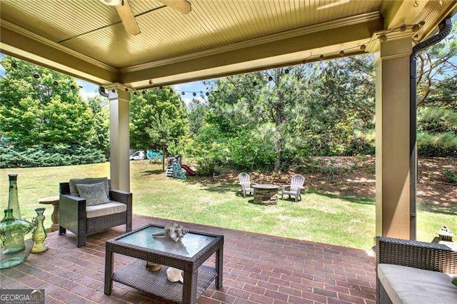 view of patio / terrace with an outdoor fire pit and ceiling fan