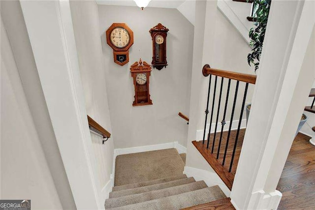 stairs with baseboards and wood finished floors