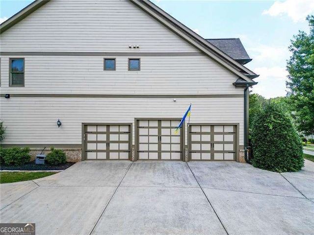 view of home's exterior featuring a garage and concrete driveway