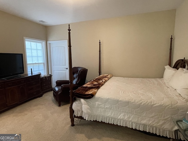 bedroom with visible vents and light carpet