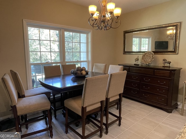 dining room featuring a notable chandelier and light tile patterned flooring