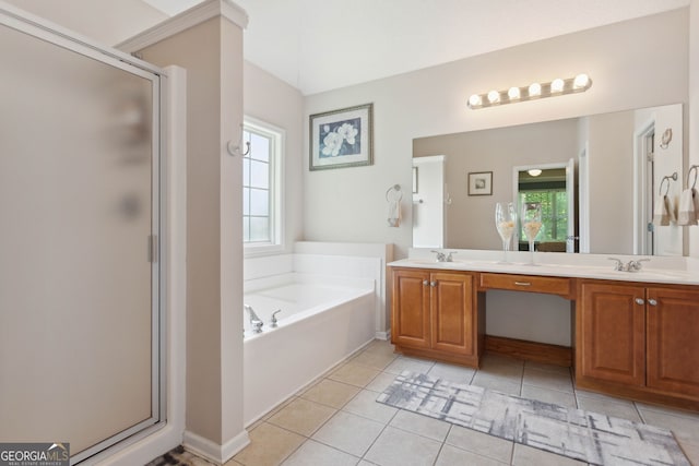 full bath featuring double vanity, a garden tub, a shower stall, and a sink