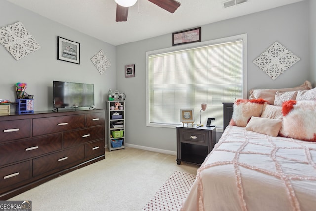 bedroom featuring a ceiling fan, light carpet, visible vents, and baseboards