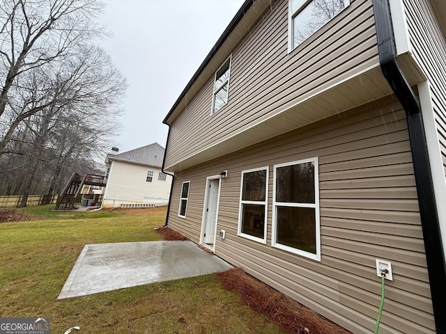 view of home's exterior featuring a patio area and a lawn