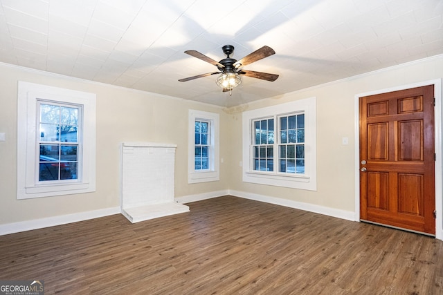 foyer entrance featuring ornamental molding, dark wood-style flooring, and baseboards