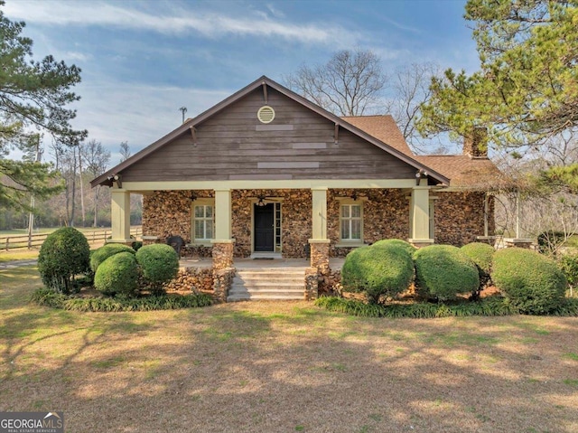 view of front of property with a chimney and a front yard