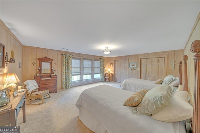 carpeted bedroom featuring multiple closets