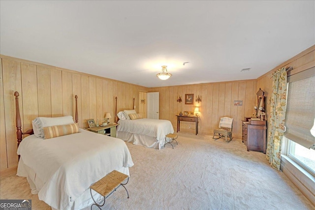 bedroom featuring visible vents and light colored carpet