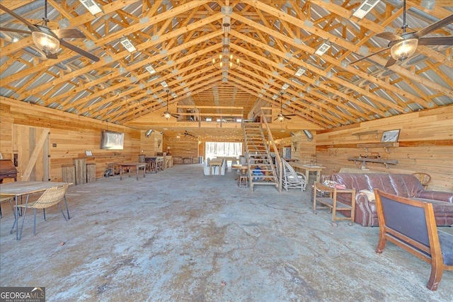 misc room featuring vaulted ceiling and wood walls