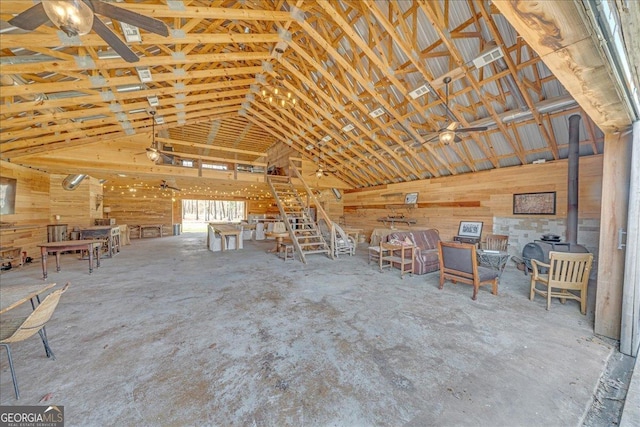 misc room with high vaulted ceiling and a wood stove