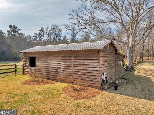 view of outdoor structure featuring an outbuilding and fence