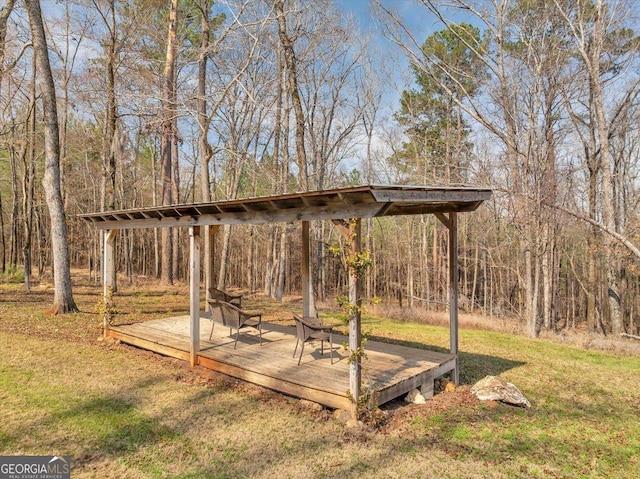 view of yard with a deck and a forest view