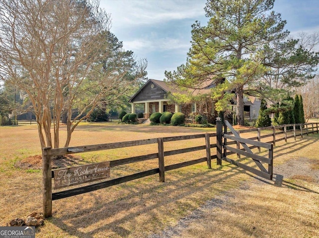 view of gate featuring a yard and fence