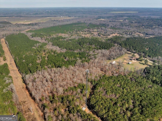 birds eye view of property with a wooded view