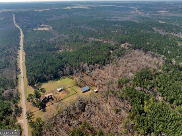 drone / aerial view featuring a view of trees