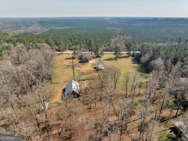 bird's eye view featuring a wooded view