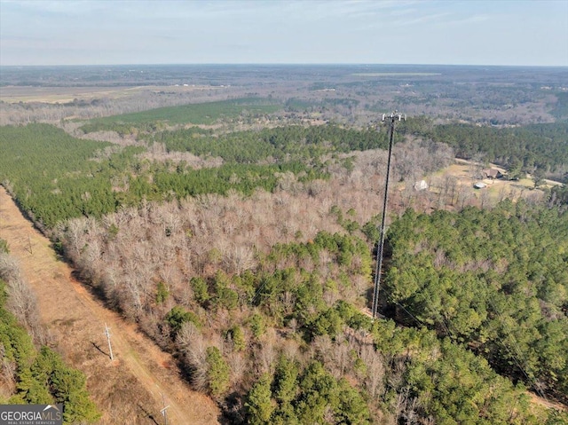 drone / aerial view with a wooded view