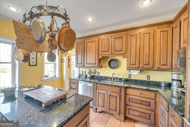 kitchen with dishwasher, ornamental molding, a sink, and brown cabinets