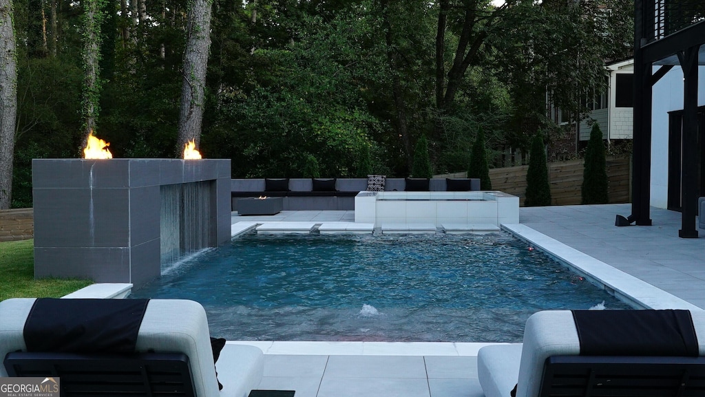 outdoor pool featuring a patio area and fence