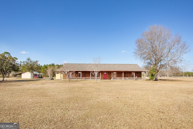 ranch-style home featuring a garage, a front lawn, and a porch