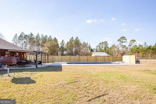 view of yard with a fenced in pool, a patio area, and a fenced backyard