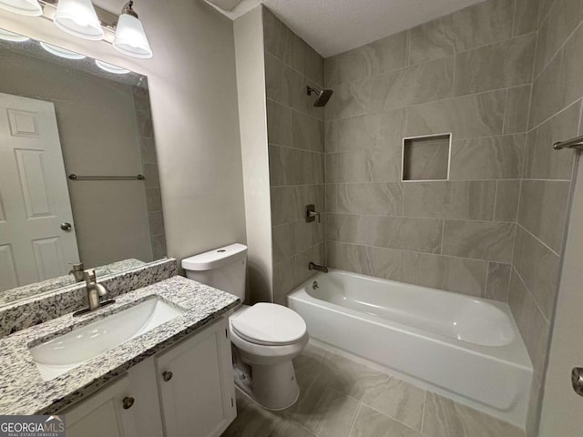 bathroom with toilet, vanity, and bathing tub / shower combination