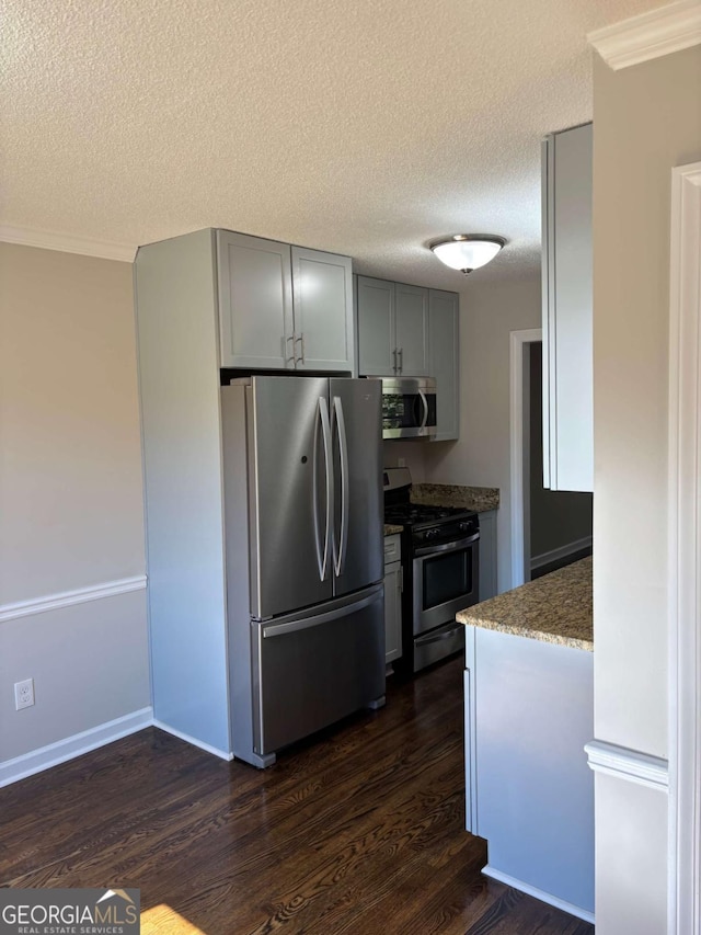 kitchen featuring stainless steel appliances, dark wood-style flooring, stone counters, and gray cabinetry