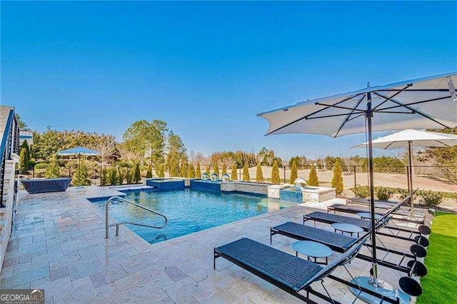 view of pool with a patio area and a pool with connected hot tub