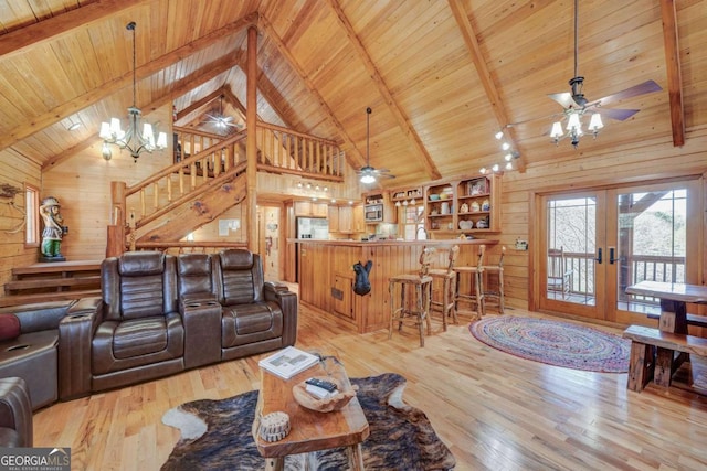 living area with beam ceiling, wood ceiling, wood walls, and light wood finished floors