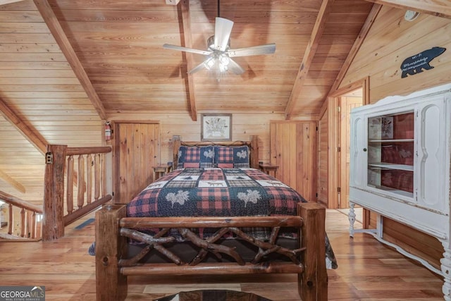 bedroom with wood ceiling, vaulted ceiling with beams, wood walls, and wood finished floors