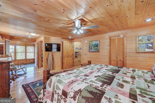 bedroom featuring wood ceiling, wooden walls, and wood finished floors