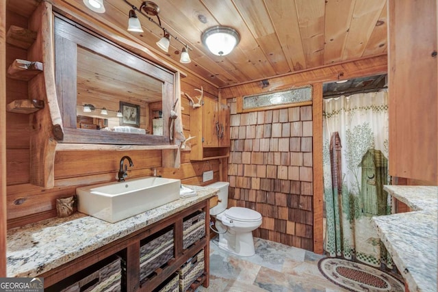 full bath featuring a shower with shower curtain, toilet, wood walls, vanity, and wooden ceiling