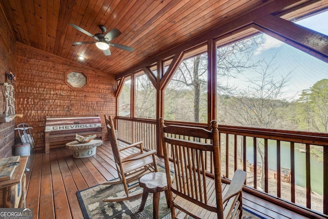 unfurnished sunroom featuring wooden ceiling, vaulted ceiling, and ceiling fan