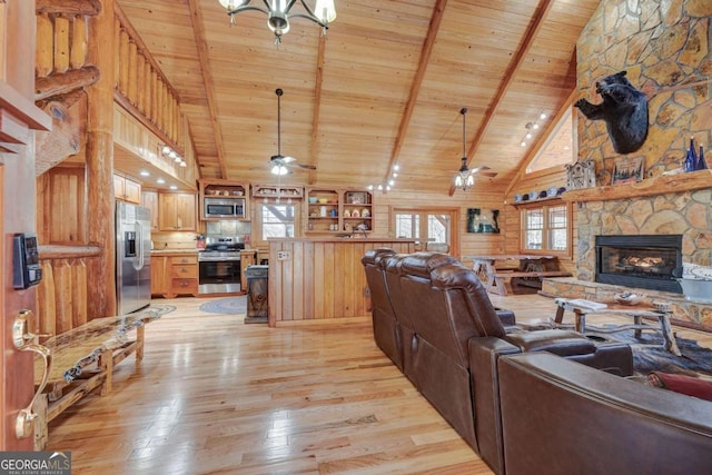 living area with a healthy amount of sunlight, light wood-style flooring, and ceiling fan with notable chandelier