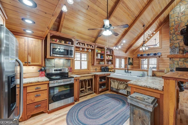 kitchen featuring appliances with stainless steel finishes, beamed ceiling, light wood finished floors, and open shelves