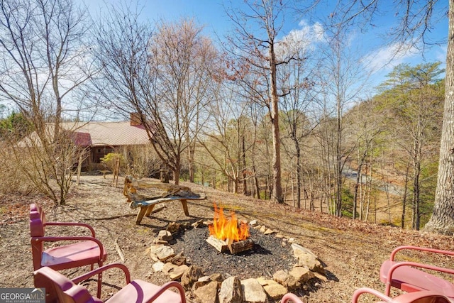 view of yard featuring an outdoor fire pit