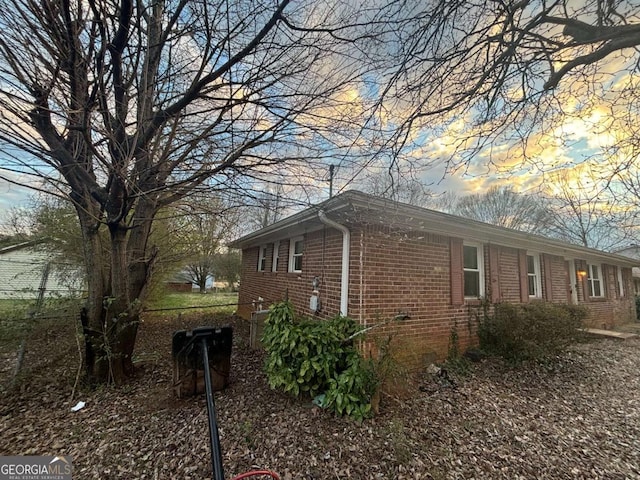 view of property exterior with brick siding