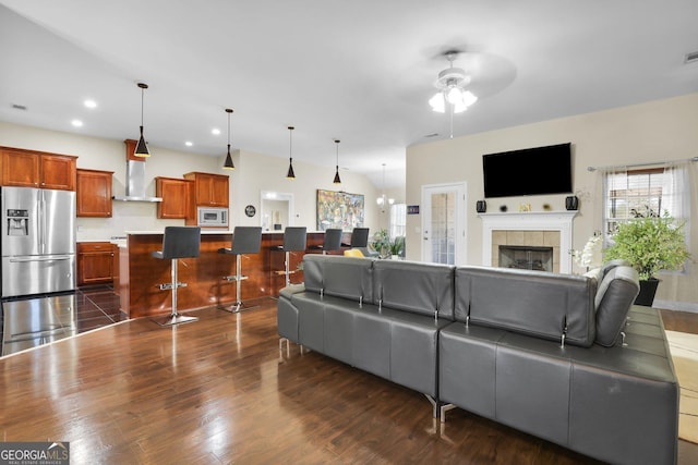 living area with visible vents, a tile fireplace, dark wood-style floors, ceiling fan, and recessed lighting