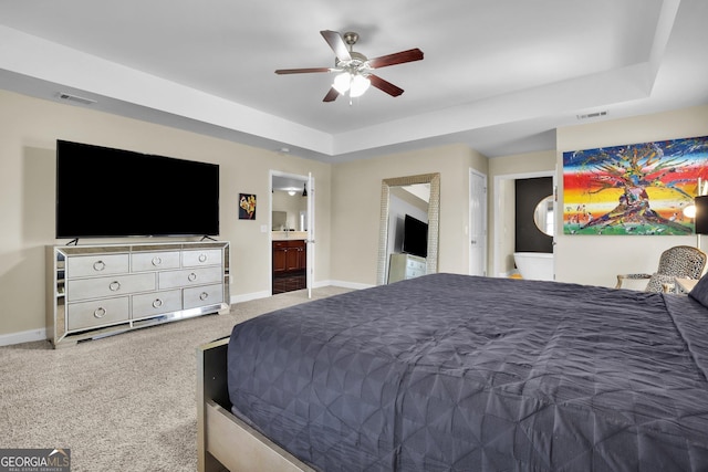 carpeted bedroom with a ceiling fan, visible vents, connected bathroom, and baseboards