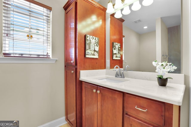 bathroom with visible vents, vanity, and baseboards