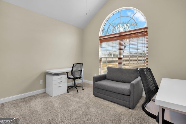 office area with high vaulted ceiling, light carpet, and baseboards