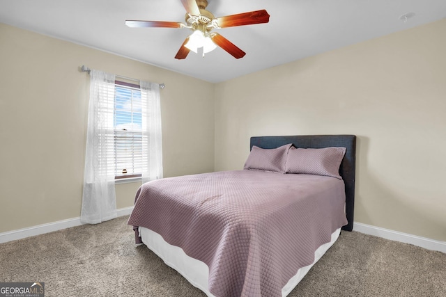 carpeted bedroom featuring ceiling fan and baseboards